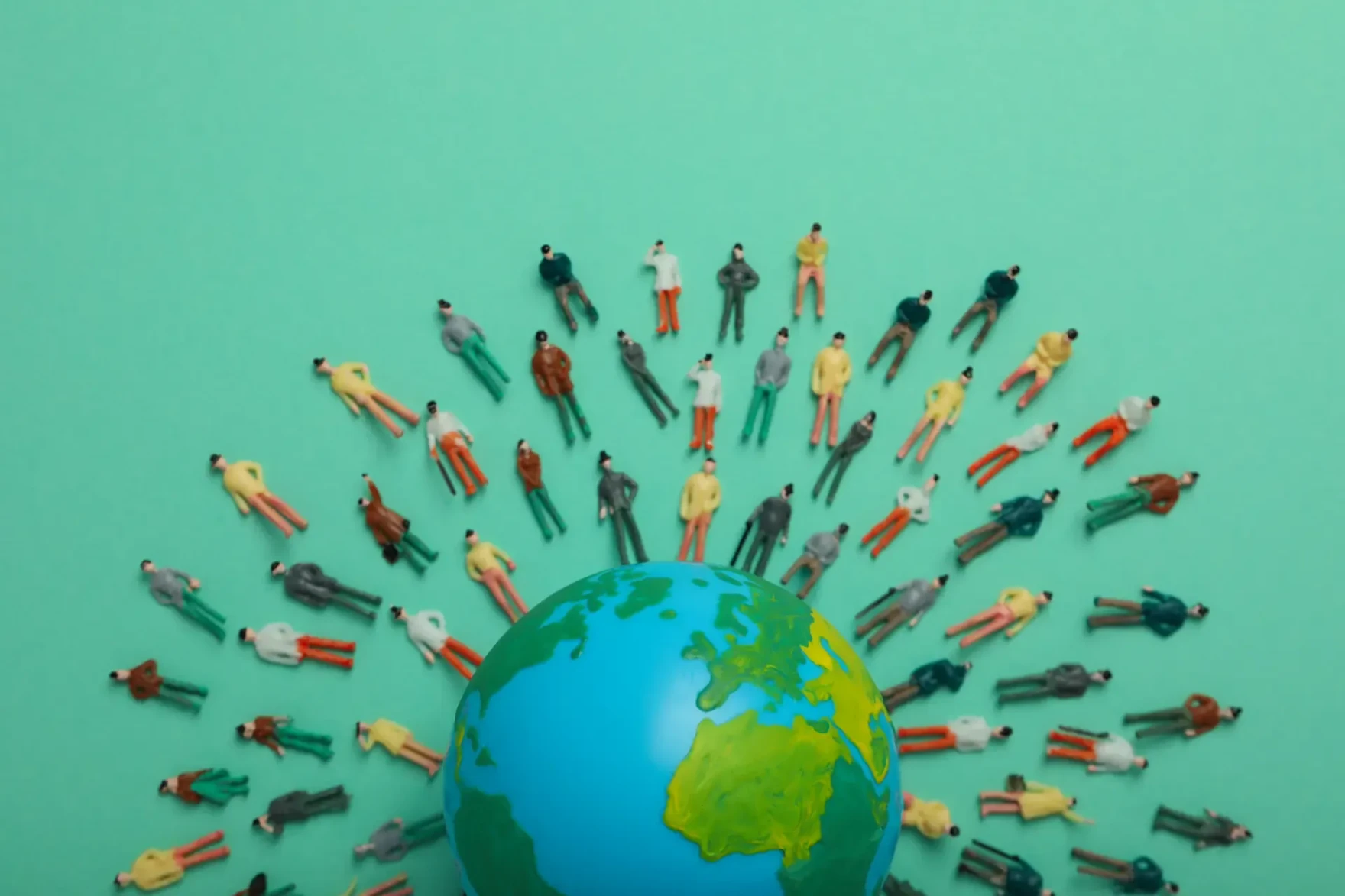 People figures arranged around a globe representing population health