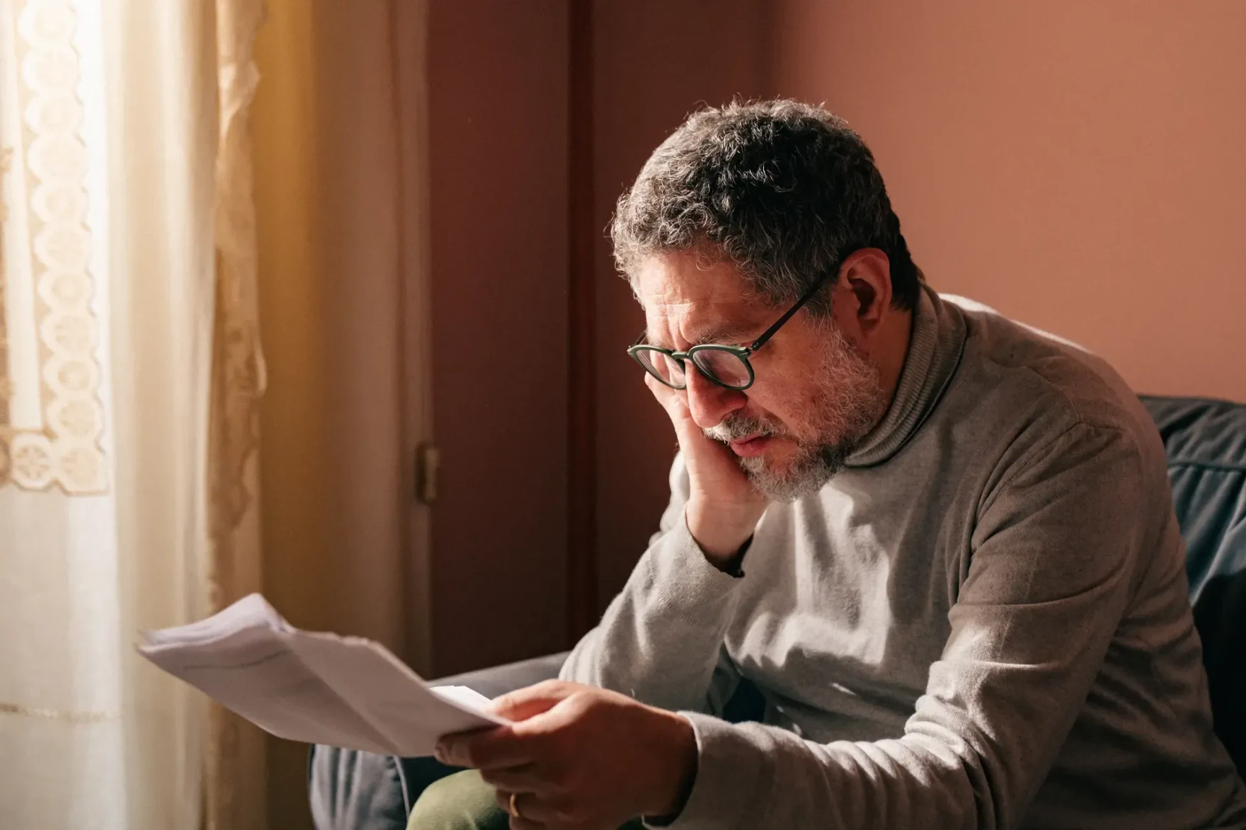 Patient reviewing medical billing documents at home
