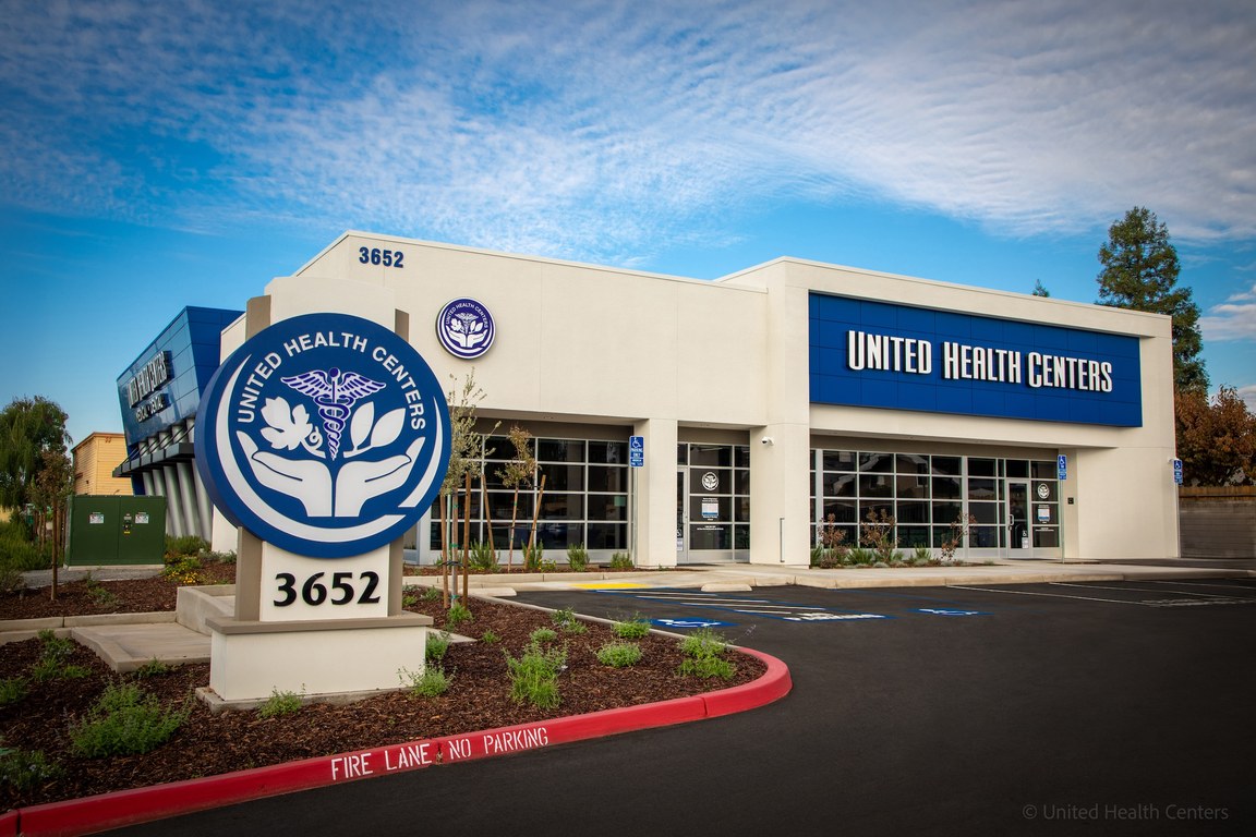 The exterior of a United Health Centers clinic, with the organization’s sign in the foreground